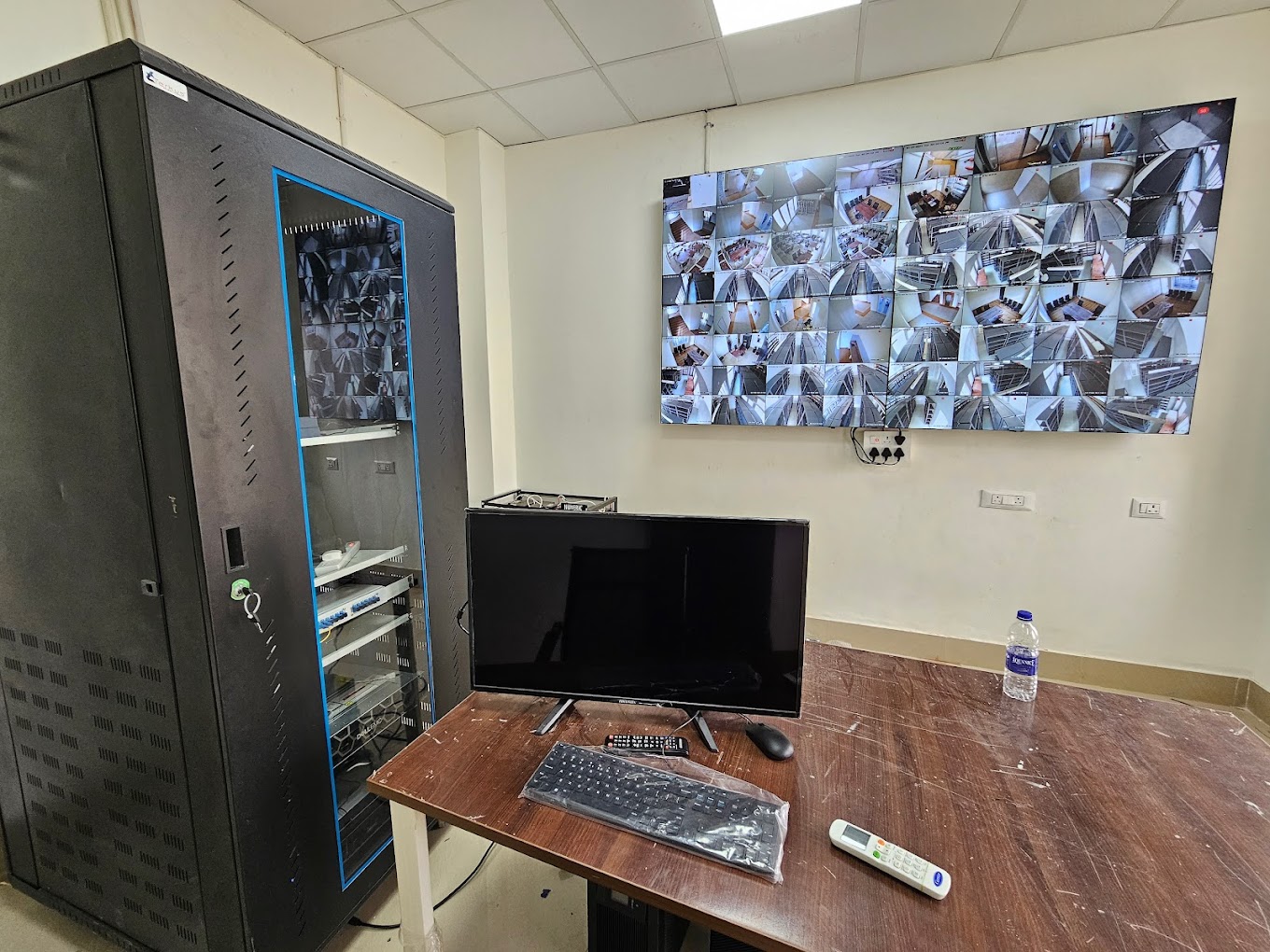 Integrated security control room with CCTV video wall and equipment rack